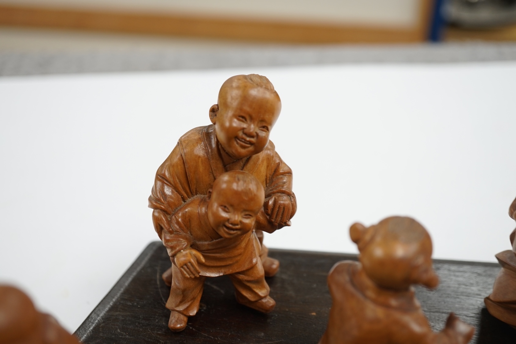 A set five Chinese carved boxwood figures of children playing Blind man’s Buff, Republic period, 23cm wide. Condition - good